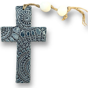 Hand made hanging ceramic wall cross in denim blue with unique intricate pattern imprinted