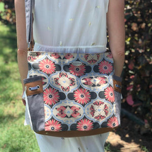 This bag is decorated with a flower and butterfly mandala and made in canvas and PU