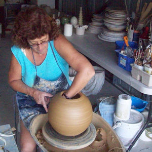 Wendy Britton at work on her potters wheel at her Queensland studio