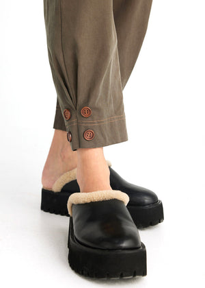 Close up view of the Artemis pant leg with four buttons at base