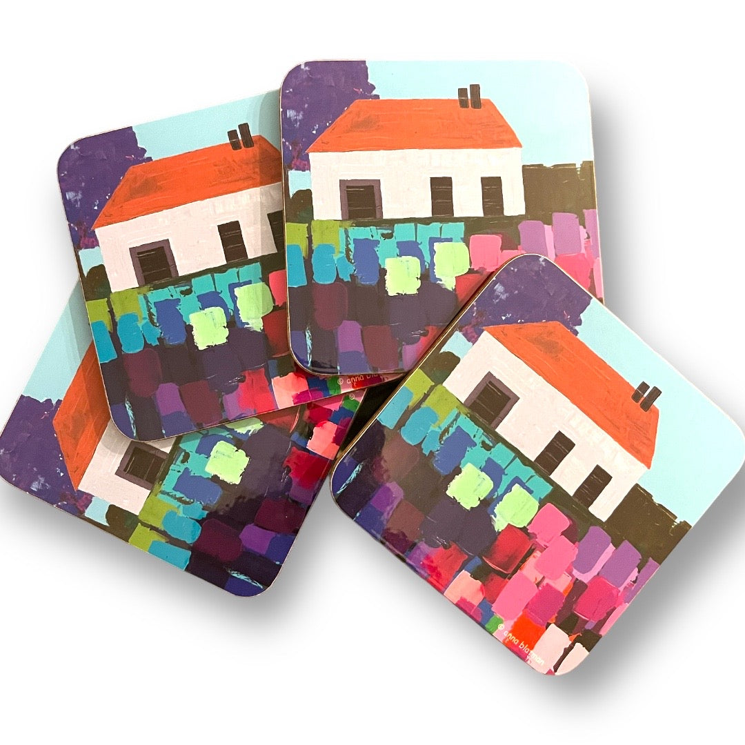 Set of 4 coasters with image of cottage and colourful flowers by Anna Blatman