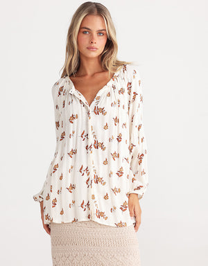 Long sleeve loose fit shirt in white with subtle flower prints in rust by Talisman