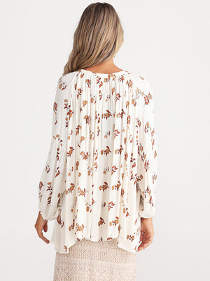 Rear view of Long sleeve loose fit shirt in white with subtle flower prints in rust by Talisman