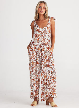 Temple Jumpsuit from Talisman in white with flower print in rust tones