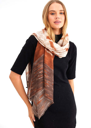 Our Penelope scarf from Holiday is lightweight and in cream, rust and brown tones