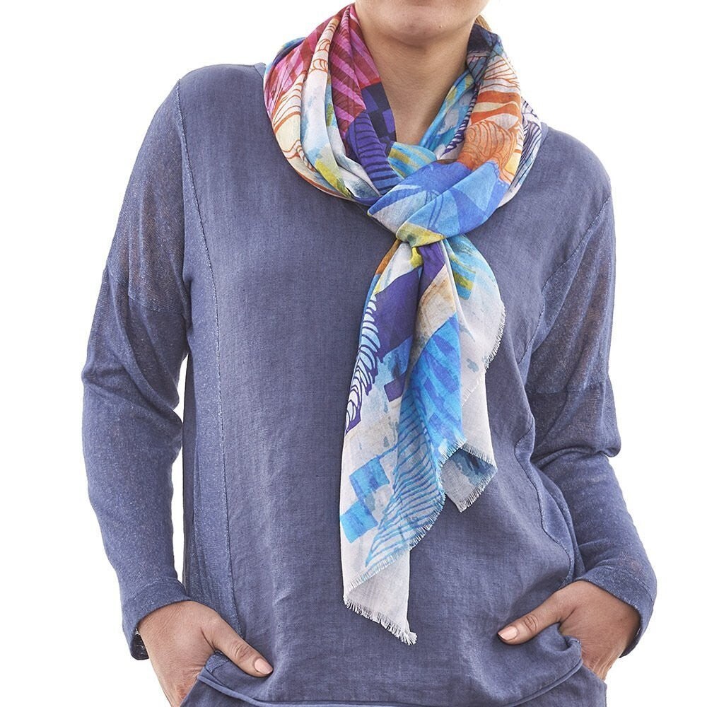 The Tempo Digital scarf encases colours of blue, pink, orange and white which makes this natural fibre scarf suitable for most of your clothes  