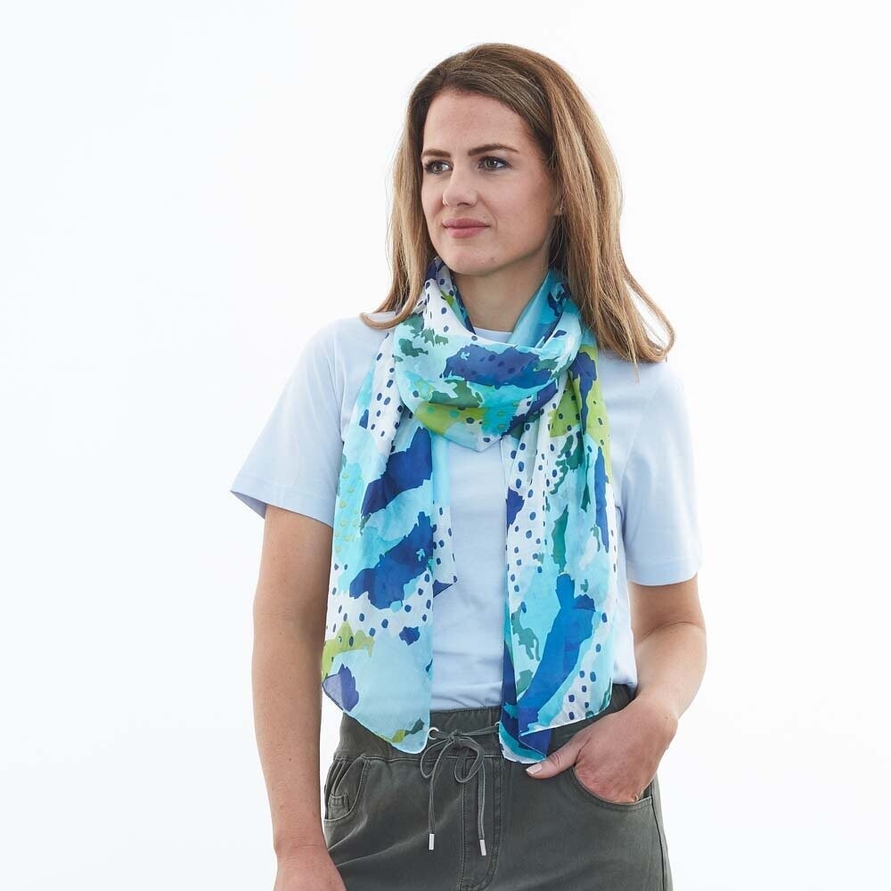 Our silk scarves are so beautiful against the skin and you won't be disappointed with our Sunday Spot scarf in shades of ocean blue from DLUX