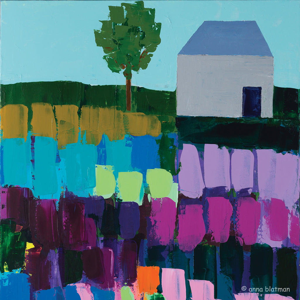 A lonely house and single tree set on a hill with fields of vibrant colours in blues, purples, tan and mint is on this coaster, painted by Anna Blatman and titled Heacham