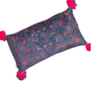 The back of this cushion from Natural Life has a blue and pink tapestry design