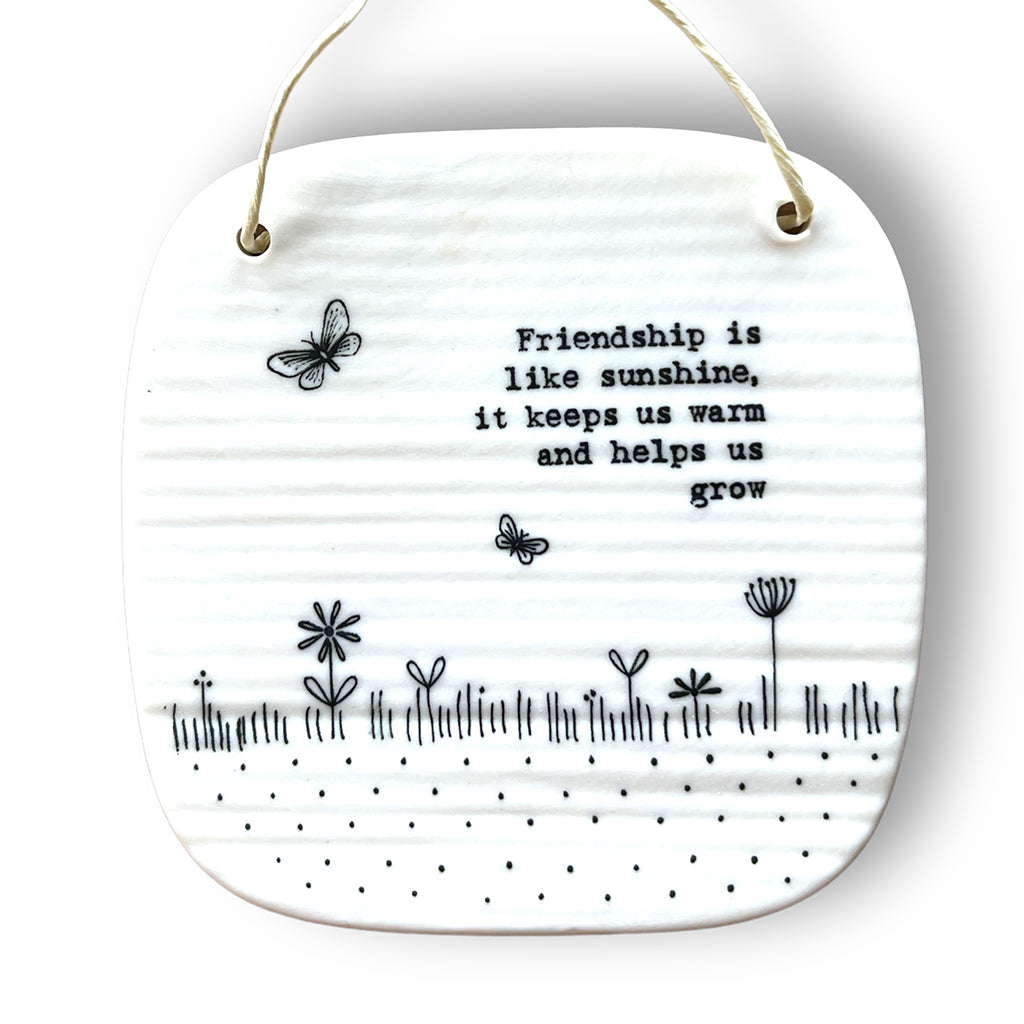 Square porcelain plaque with the words &#39;Friendship is like sunshine, it keeps us grow&#39; with picture of grass, flowers and butterflies