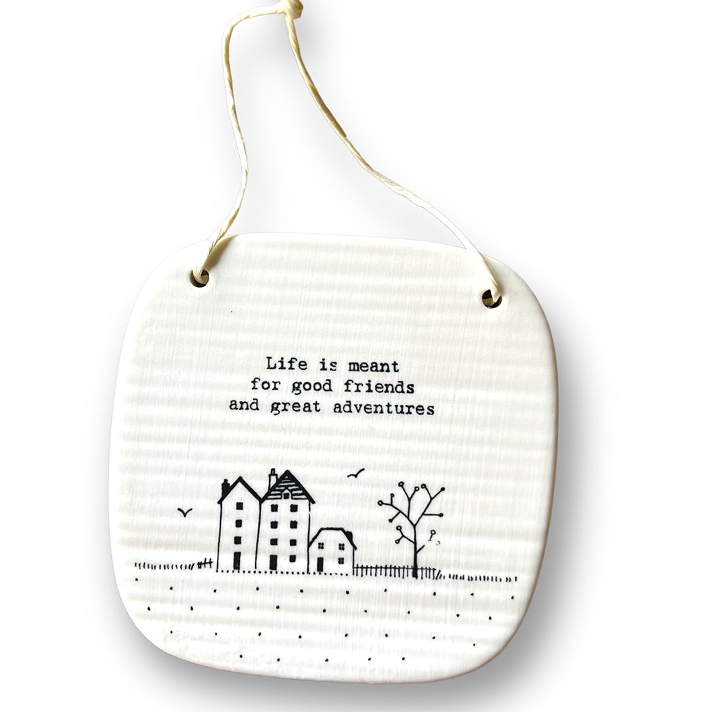 Square porcelain plaque with a picture of three buildings and a tree with the words &#39;Life is meant for good friends and great adventures&#39;