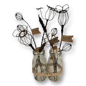 A selection of handmade wire flowers including poppies, berries, cow parsley and bullrush