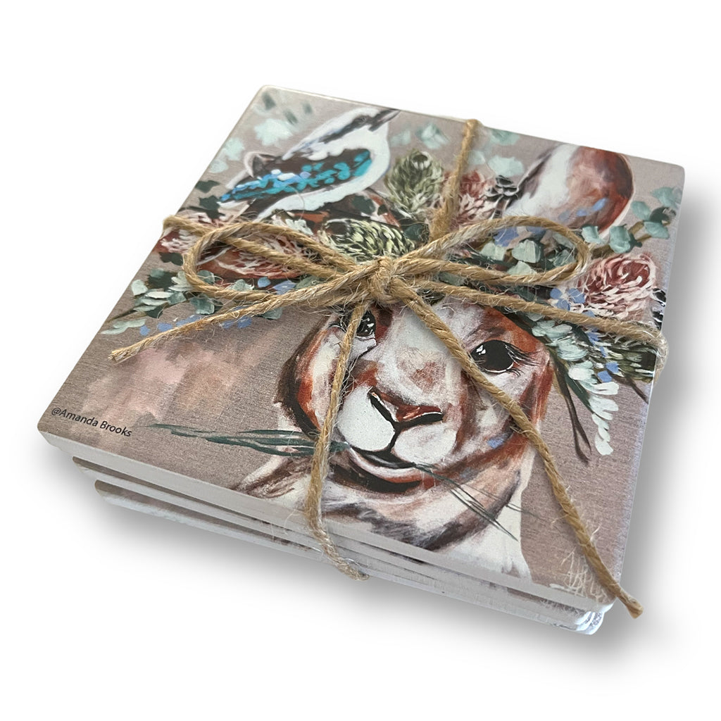 Set of four coasters with kangaroo and kookaburra image tied together with jute