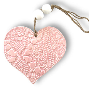 Hand made ceramic hanging heart in pale pink colour with unique 3D pattern by Australian sculptor Wendy Britton