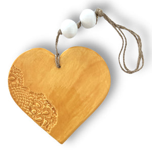 Hand made ceramic hanging heart in sunflower colour with unique 3D pattern by Australian sculptor Wendy Britton