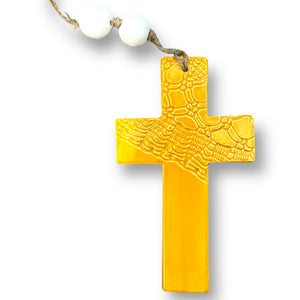 Hand made hanging ceramic wall cross in buttercup yellow with unique intricate pattern imprinted