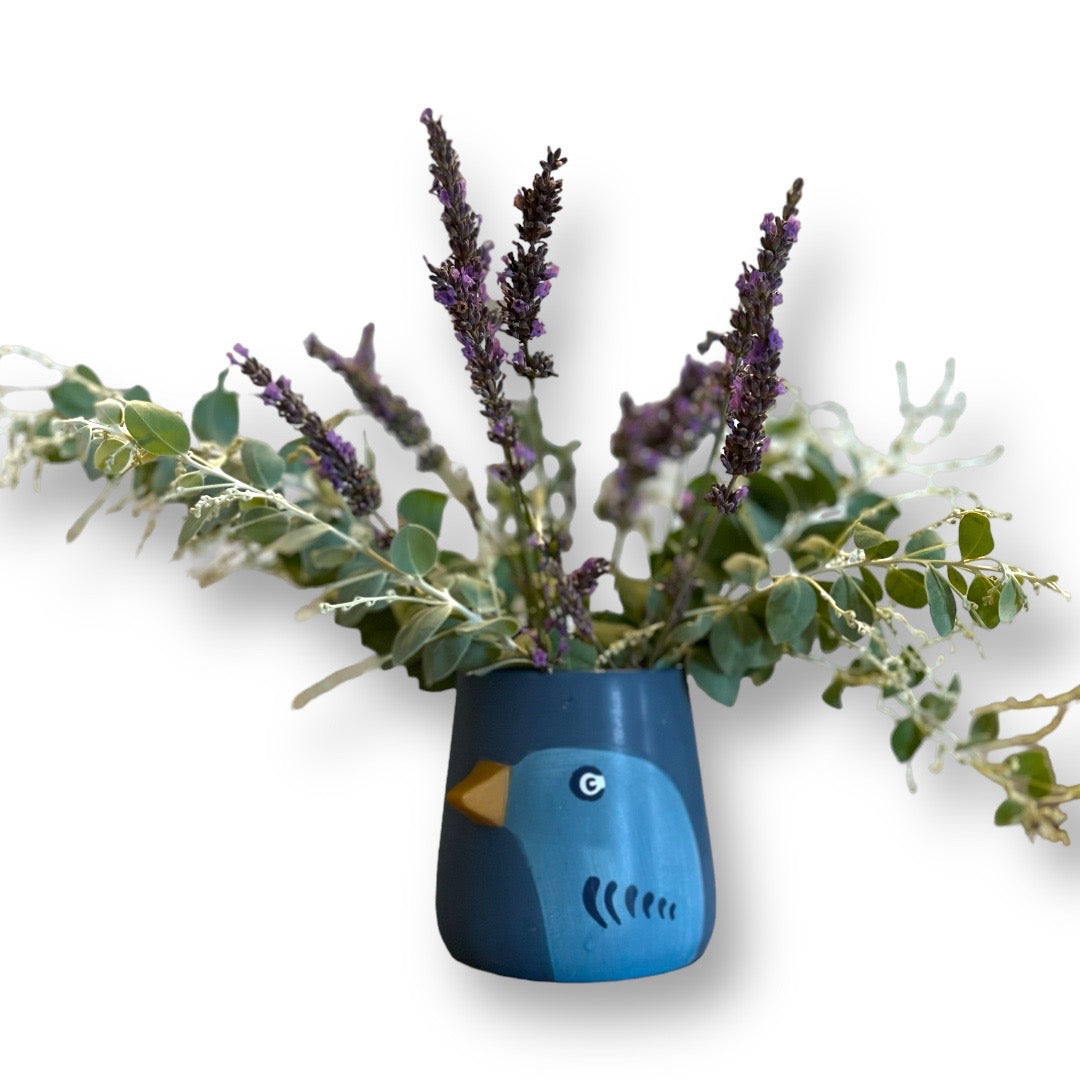 This sweet planter/vase has a dark blue background with an images of a blue coloured bird and 3D beak