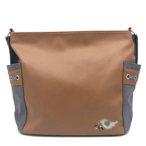 The Everyday Tote has two different sides, one being canvas with the butterfly design, and the other, a tan PU finish with the signature bsirius bird stitched on the bottom corner