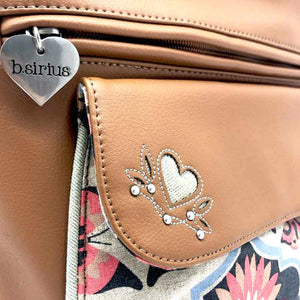 Original and top quality details with the heart and leaf design embedded on the magnetic flap